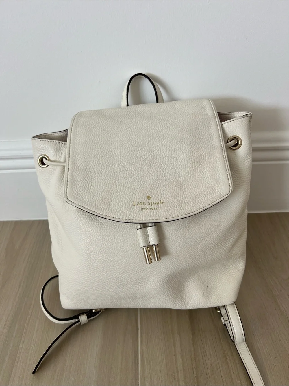 Kate Spade New York creamy white leather drawstring flap backpack